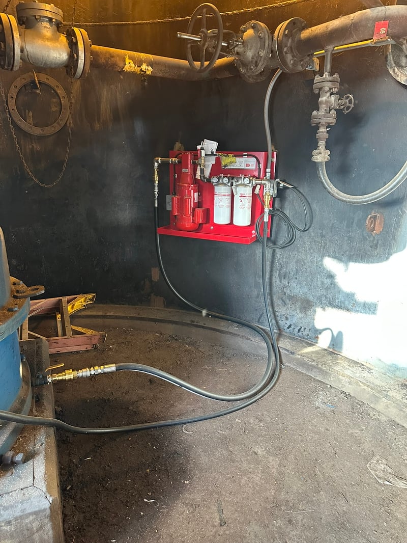 Wall-mounted Trico filtration system serving an industrial gearbox