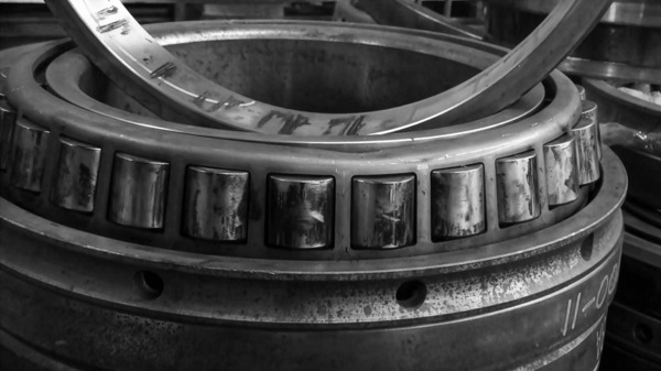 Technician inspecting a large bearing at an NSK reconditioning center