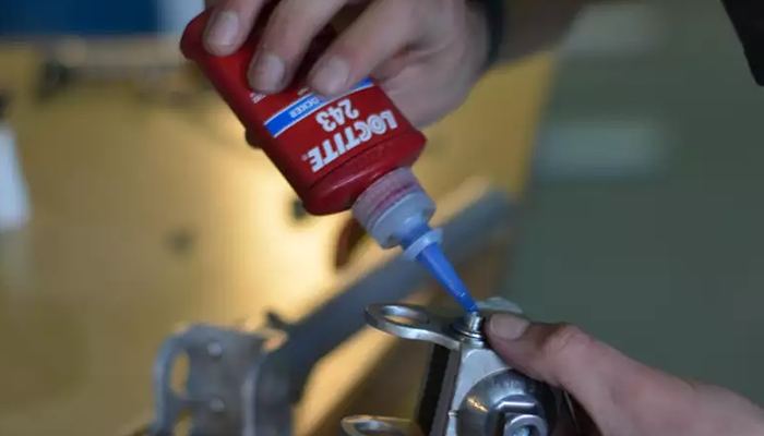 Loctite threadlocker applied to industrial threaded fastener