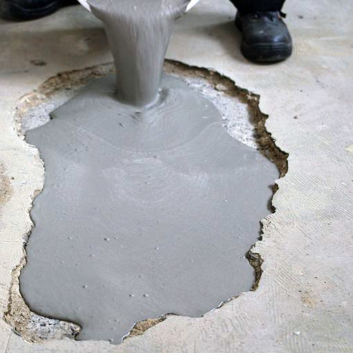 Concrete repair professional applying repair compound